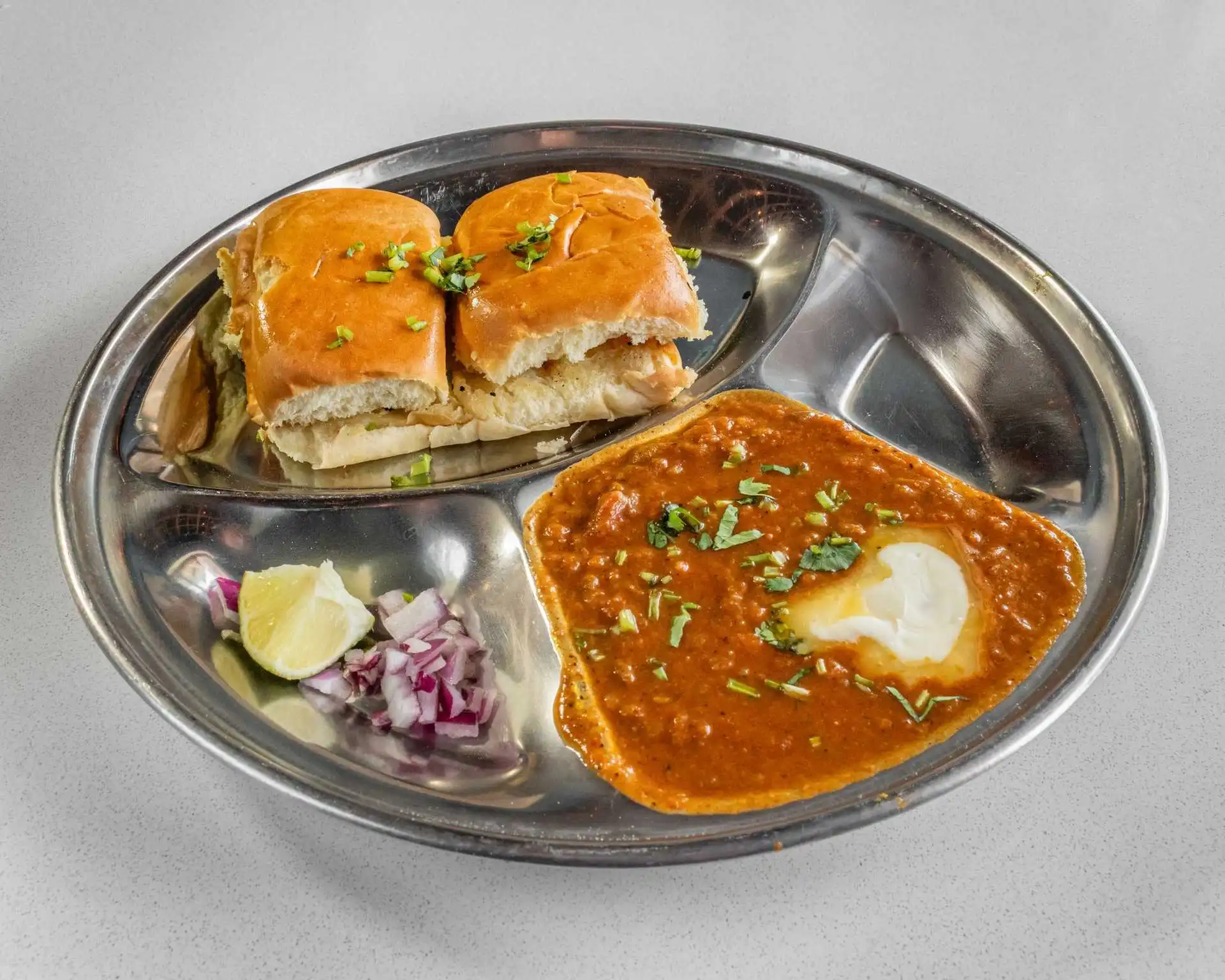Spiced vegetable curry with buttered buns, reflecting the Indian-inspired flavours of the Shahi Paneer Pizza at Samra Pizza Calgary