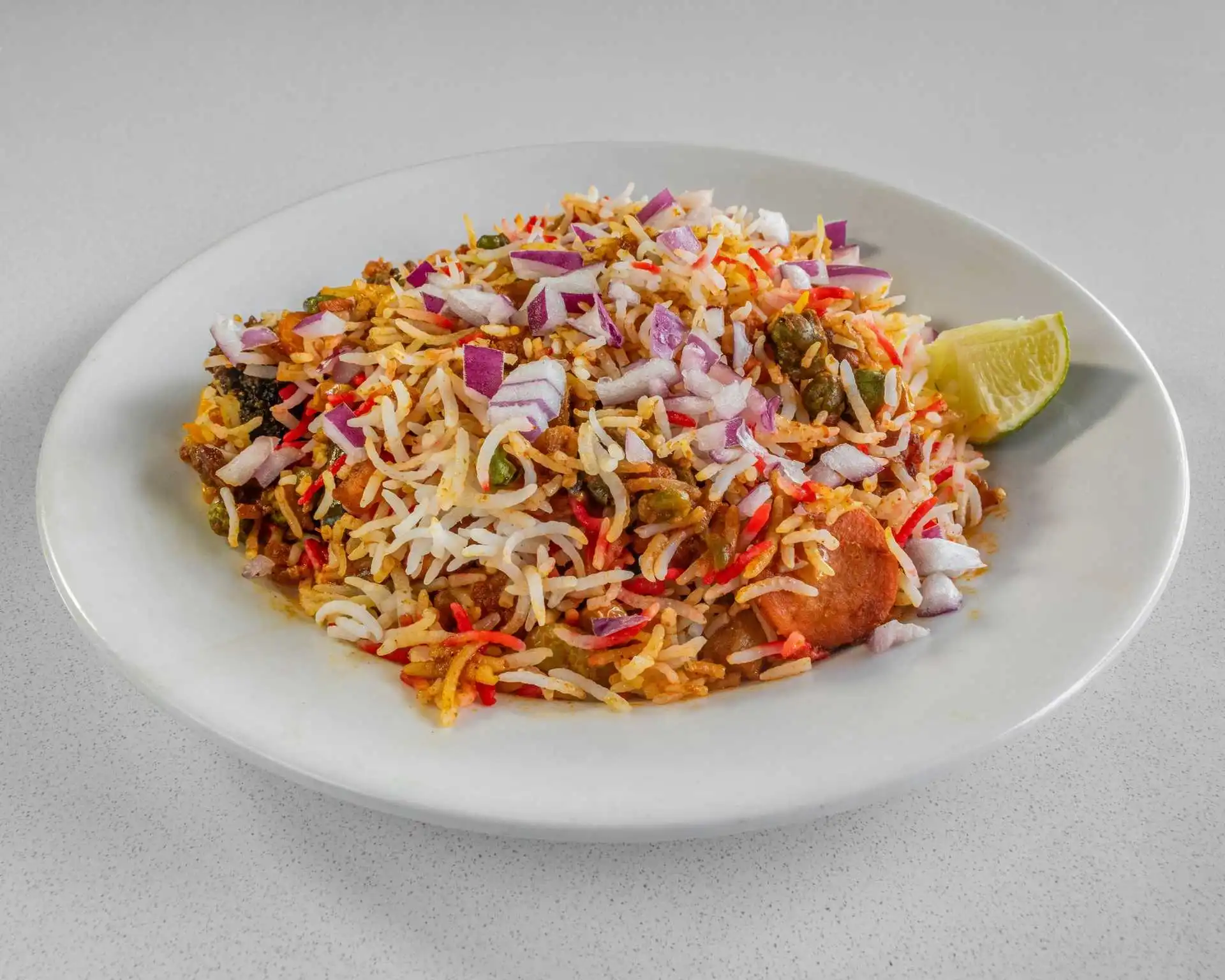 Seasoned rice plate with diced onions and lime at Samra Pizza near Sage Valley Common NW