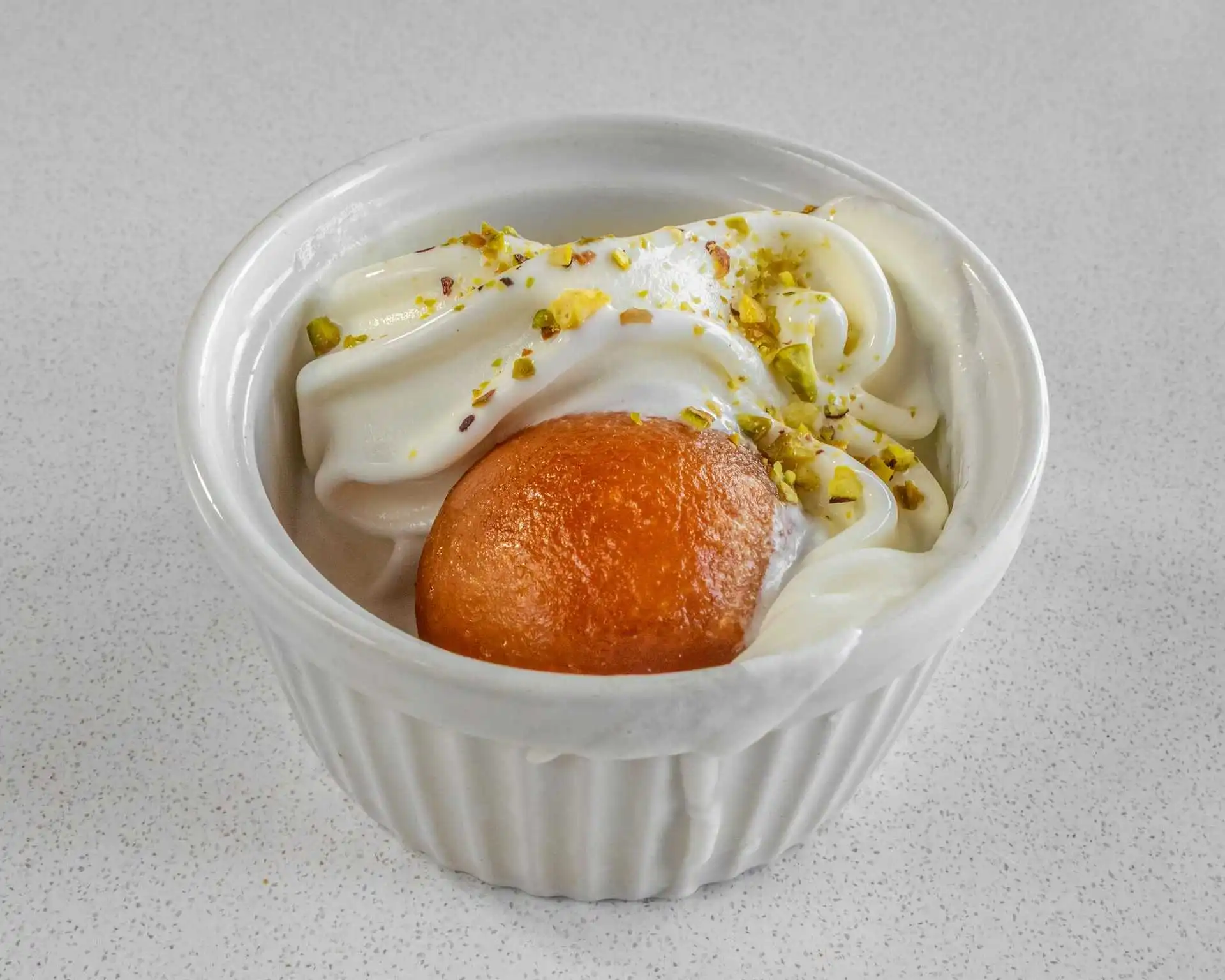 Soft-serve dessert cup topped with crushed pistachios at Samra Pizza in Sage Hill, Calgary
