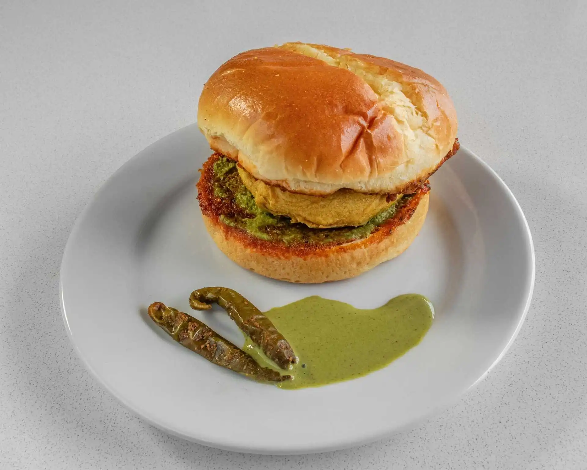 Toasted bun sandwich with green chutney and fried chilies at Samra Pizza in Sage Hill, Calgary